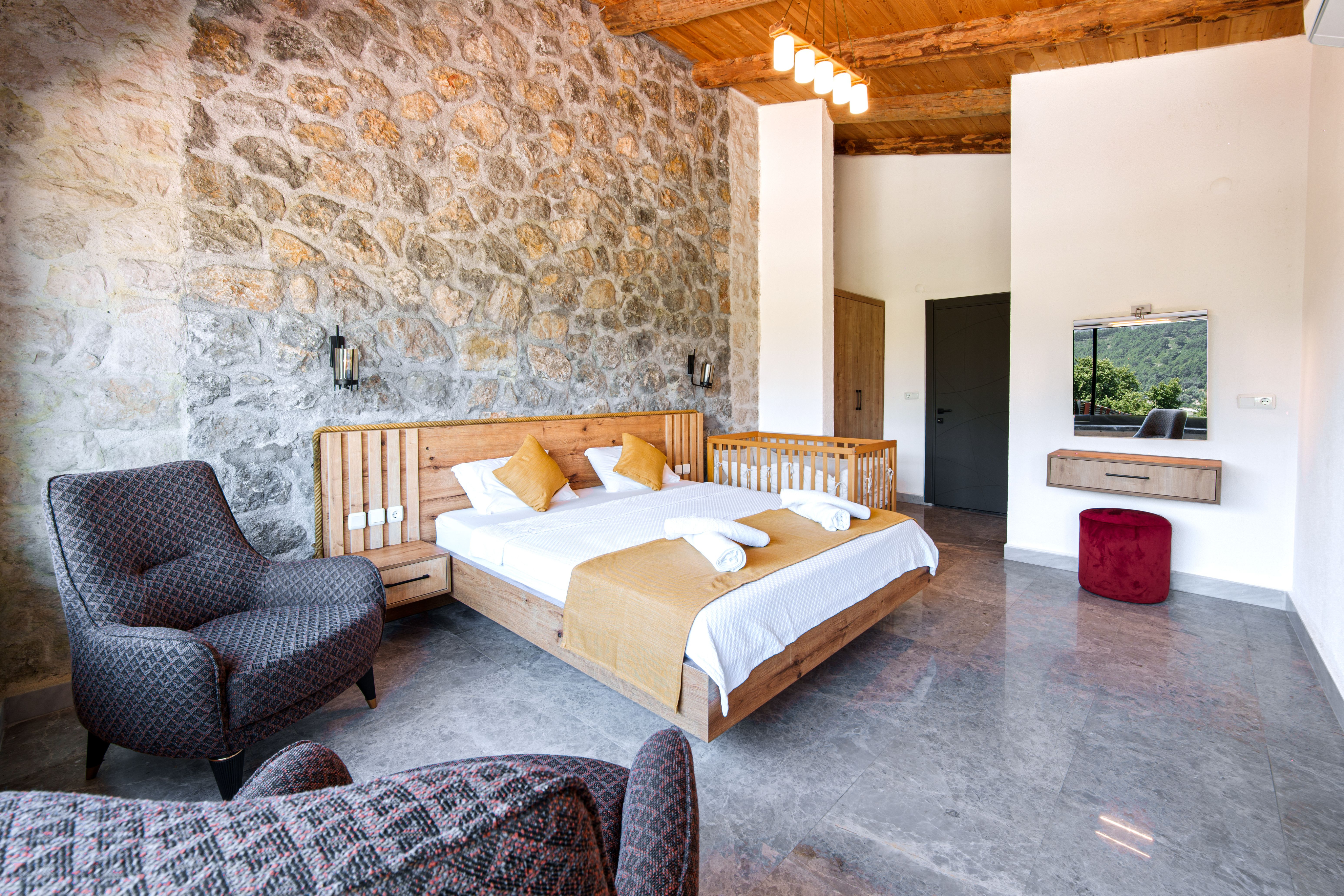 Regular room with a double bed and stone walls